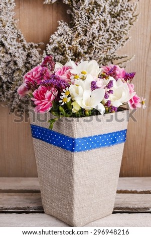 Bouquet of carnations and freesia flowers in a box