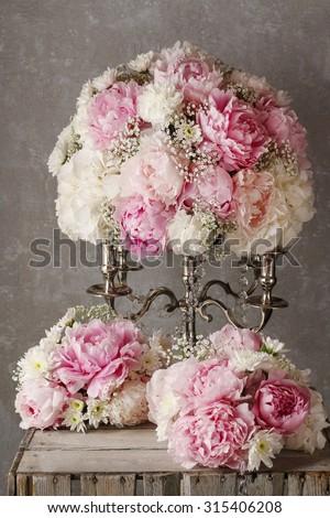 Floral arrangement with pink peonies, white chrysanthemums and gypsophila paniculata twigs