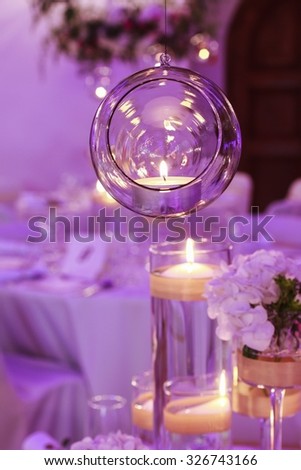 Glass sphere with candle inside. Beautiful wedding decoration.