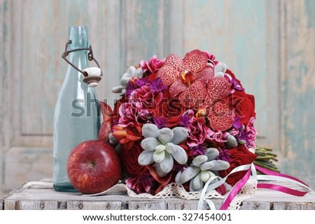 Bouquet with red orchid flowers, roses and succulents