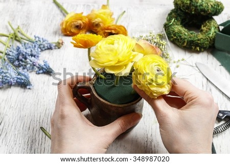 Florist at work: how to make bouquet of ranunculus (Persian buttercup) and muscari (Grape hyacinth) flowers. Step by step, tutorial.