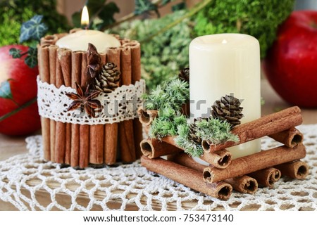 Candle decorated with cinnamon sticks. Christmas table decoration.