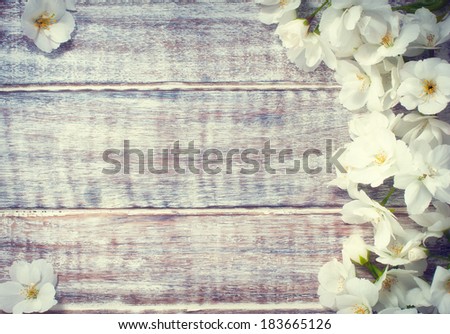 colorful floral frame on rustic wooden background/spring or summer background