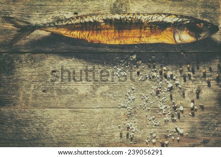 Smoked fish with spices on a rustic background