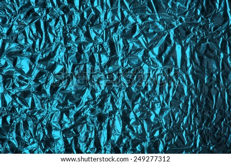 Thin sheet , leaf background with shiny crumpled uneven surface