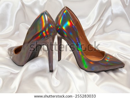 high heel women shoes on white silk background