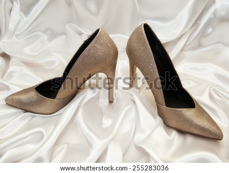 high heel women shoes on white silk background