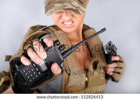 Army woman with radio and  with gun