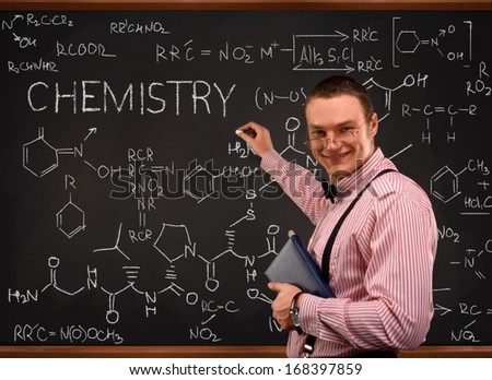 Young  teacher portrait with blackboard background (mathematic)