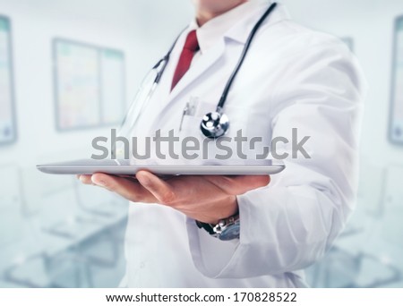 Close Up Of Male Doctor Holding Tablet