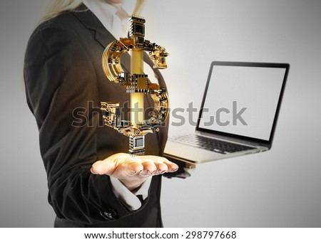 Young  beautiful Businesswoman with laptop and dollar money sign in hand on gray background