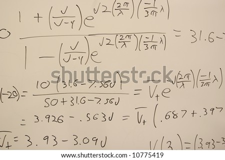 White board with handwritten science equations written in marker