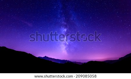 Milky Way Galaxy. Purple night sky stars above mountains