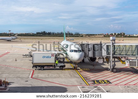 BARI, ITALY - SEPTEMBER 14: ALITALIA airplane parked at terminal. loading and maintenance operations before to flight. KAROL WOJTYLA AIRPORT