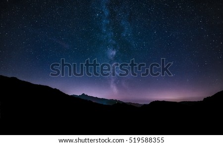 purple night sky stars. Milky way galaxy across mountains.