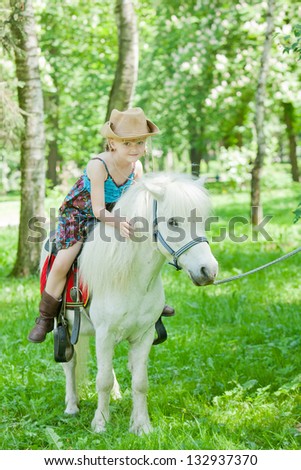 Girls take a walk with pony