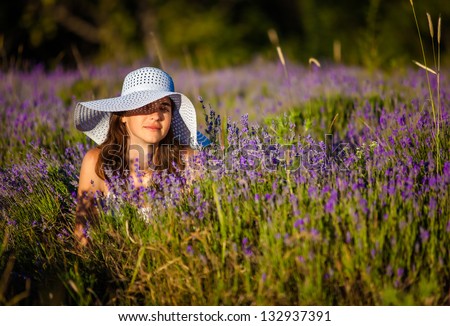 Young woman at lavender field at the sunrise
