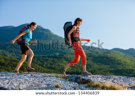 Two women is trekking in the Crimea mountains with backpacks