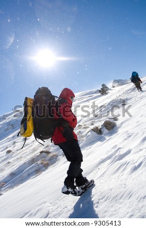 Tourists are in winter in mountains