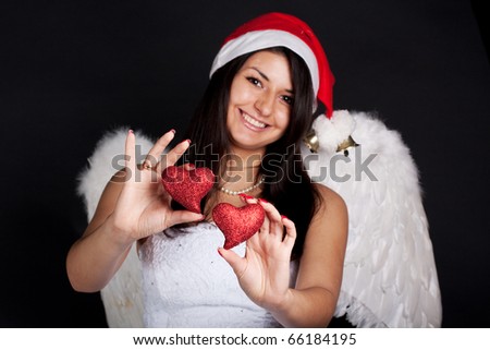 Woman angel shows hearts toys