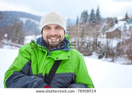 Hiker took a rest in snow forest near village