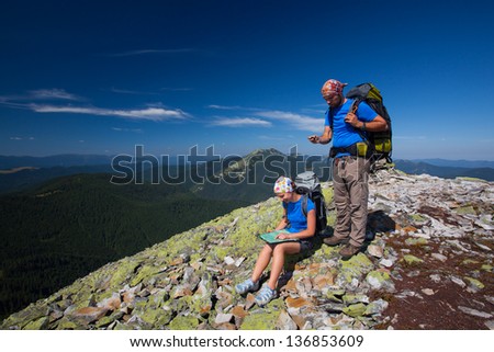 Portrait of couple at the top of the mountain that search for the path