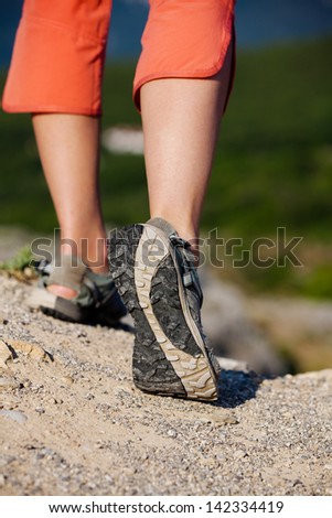 Trekker makes her way in sandals closeup