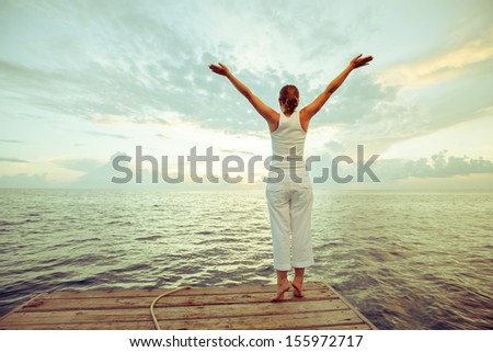 Caucasian woman practicing yoga at seashore Caucasian woman practicing yoga at seashore
