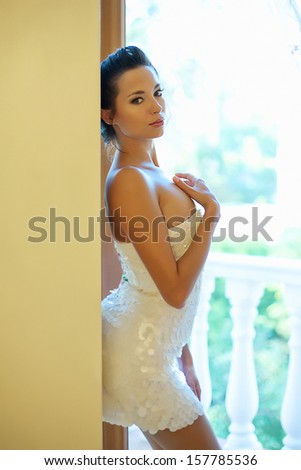 woman standing at the window in the morning