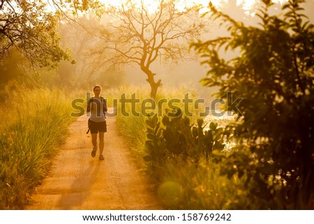Woman has walk at the lakeside during sunrise