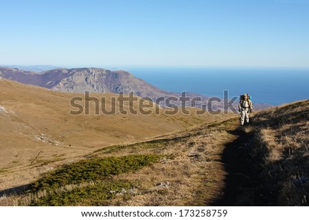 Hiker is descending mountain in Crimea mountains