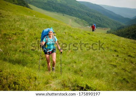 Young people are hiking in Carpathian mountains in summertime