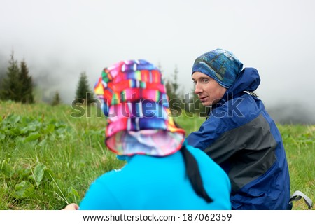 Hikers talk while rest in mountains
