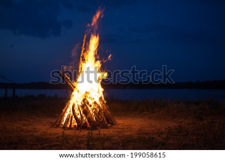 Big campfire at the river after sunset Big campfire at the river after sunset