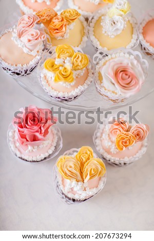 Cupcakes with individual wedding decoration at white table