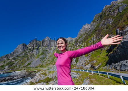 Caucasian woman is doing yoga exercises against picturesque landscapes in Norway