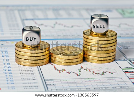 Financial chart, coins and dice cubes with the words Sell Buy. Selective focus