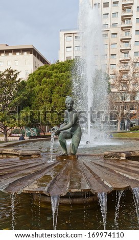 Madrid, Spain Ã¢Â?Â? December 31, 2013: Sculpture of Naiad with pitcher. Part of the fountain Birth of Water (circa 1969). Sculptor Antonio Campillo