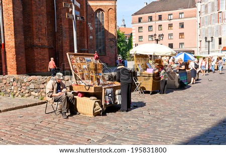 Riga, Latvia - May 25, 2014: Local souvenirs trade near Saint Peter Church in Riga, Latvia
