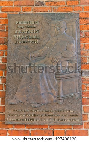 Riga, Latvia - May 25, 2014: Memorial plaque of priest Francis Trasuns, the Latgale and Latvian statesman. Wall of Saint Jacob Cathedral in Riga, Latvia