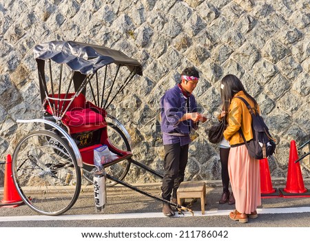 KYOTO, JAPAN - APRIL 02, 2012: Pulled rickshaw man making deal with the clients in Kyoto, Japan