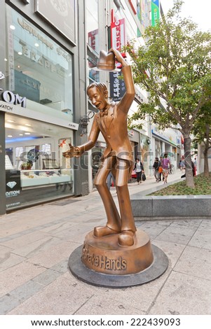 BUSAN, SOUTH KOREA - SEPTEMBER 25, 2014:  Sculpture of a man Lets Shake Hands on Gwangbok street in Busan, Republic of Korea. Tourists shake hands with the statue