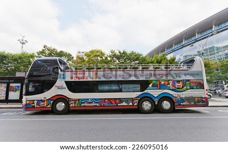 BUSAN, SOUTH KOREA - SEPTEMBER 26, 2014: Double-decker open-top city sightseeing bus waiting for tourists near Railway Station in Busan town, Republic of Korea
