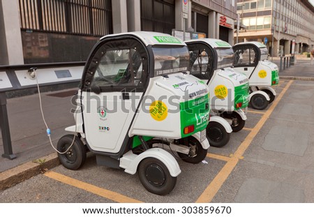 MILAN, ITALY - APRIL 11, 2015: Three small two-seater electric automobiles charging on the street of Milan, Italy