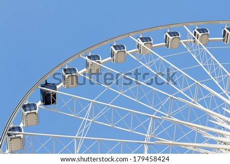 Photo of ferris wheel in the park with clear blue sky and empty space for some text