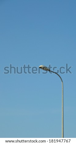Lamp street lighting on the background of blue sky.