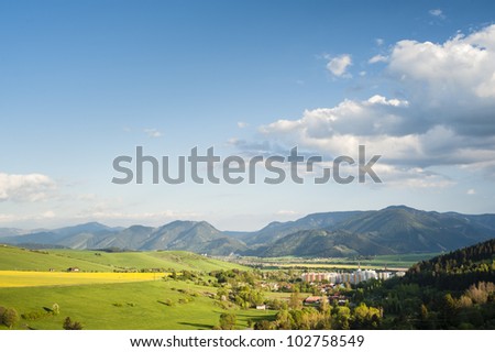 Small town under mountains in spring evening
