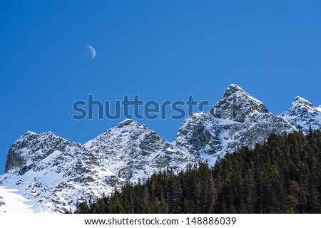 Mountains edge and Moon in winter day