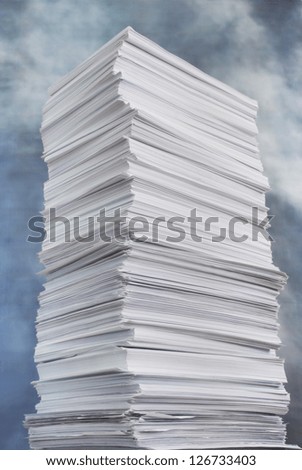 huge paper stack against the stormy sky