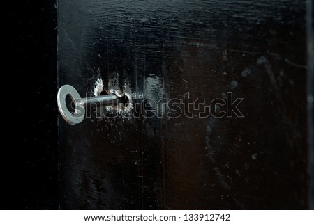 key in the black iron door